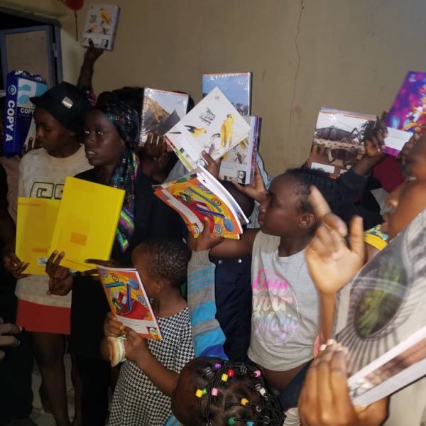 Children receiving school bags and educational materials from ZIM Foundation